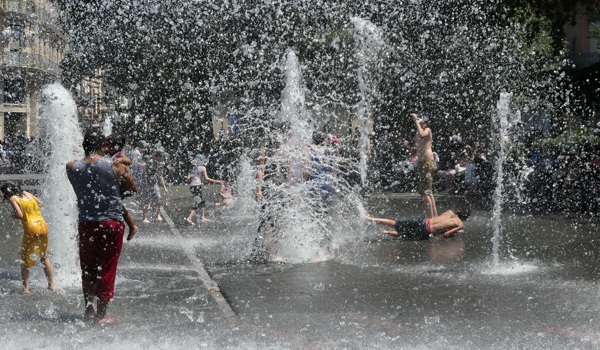 Children play in water park during heatwave